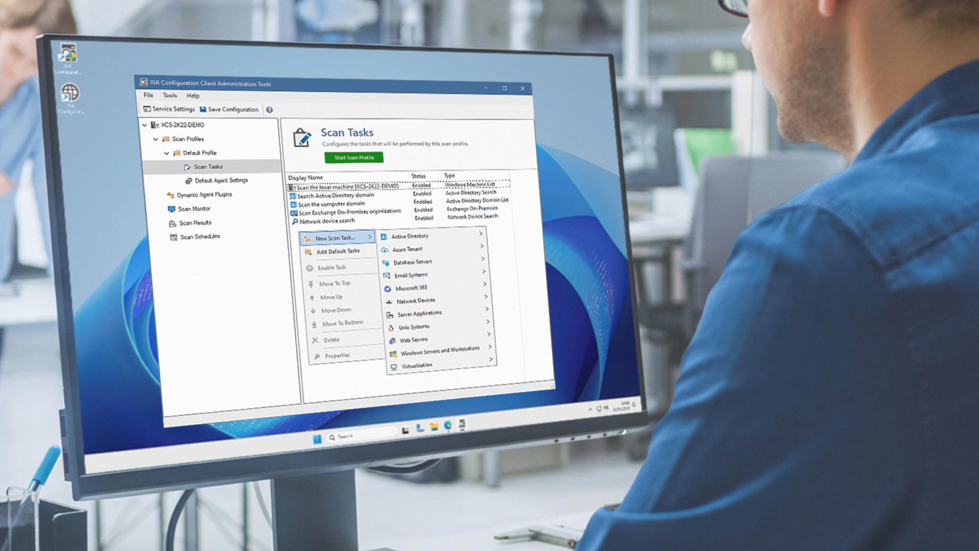 Man at a computer screen which is showing the XIA Configuration Client scan tasks